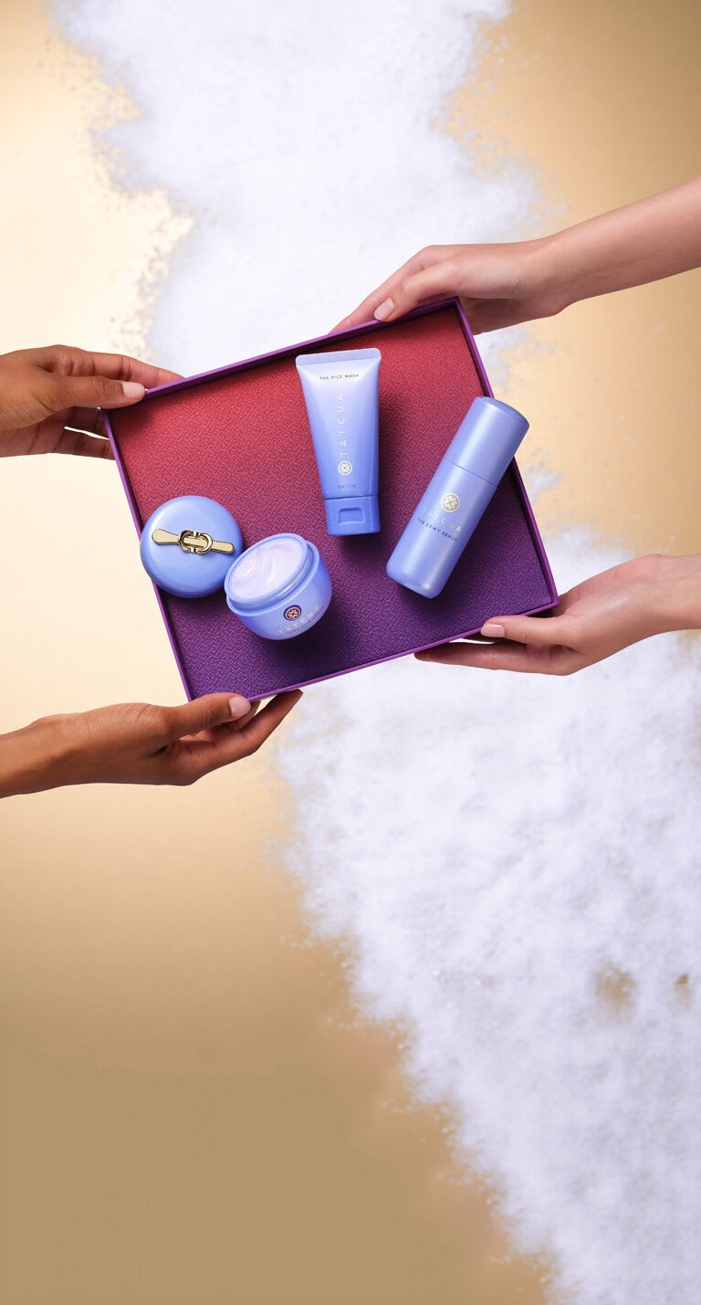 Dewy Skin Essentials being handed to another model.
